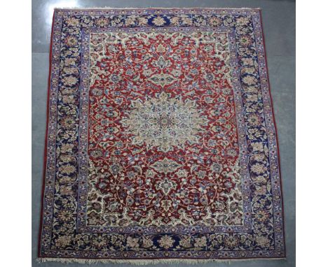 An Isfahan Najafabad carpet woven in colours with oval medallion, spandrels and filler motifs on a red ground, 360cm x 250cm 