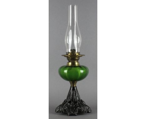 A Victorian cast and green glass oil lamp, the base marked '1887 No32 Rd40'. 31cm high. Lacking shade, otherwise good.