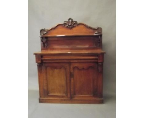 A Victorian mahogany chiffonier with two cupboards under a single moulded drawer, the upper section with shaped shelf and bac