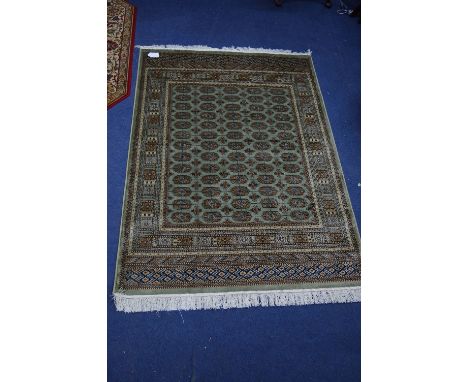 A BOKHARA STYLE RUG, green ground with central medallions, approximate size 162cm x 134cm