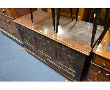 A GEORGIAN CARVED OAK TRIPLE PANEL MULE CHEST, above two drawers, approximate size width 131cm x depth 56cm x height 72cm (sd