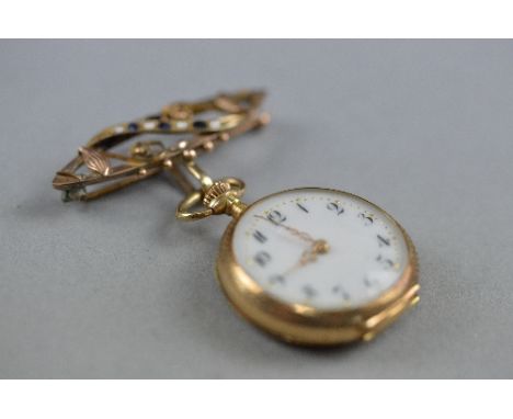 AN EARLY 20TH CENTURY LADIES FOB WATCH, white enamel dial with Arabic numerals and fancy fine scroll hands, measuring approxi