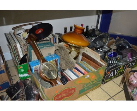 FOUR BOXES AND LOOSE SUNDRY ITEMS, to include ice skates, records, books, oil lamp, barometer, c.d's, metalware, etc