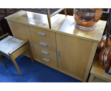 A LIGHT OAK FINISH SIDEBOARD, with four drawers central to double cupboard doors, approximate size width 137cm x depth 45cm x
