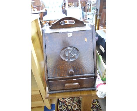AN EARLY 20TH CENTURY OAK LOG BOX, with hinged fall front with the initials C K carved to the door and a single drawer