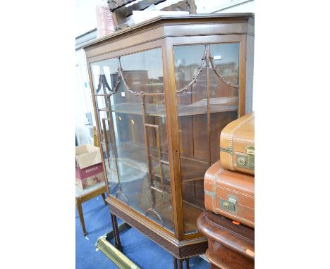 AN EDWARDIAN MAHOGANY ASTRAGAL GLAZED CANTED DISPLAY CABINET, with two shelves on four triple straight legs, approximate size