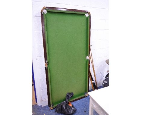 A MODERN SLATE SNOOKER TABLE, with folding legs, complete with  cues, balls and a triangle