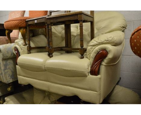 A CREAM LEATHER THREE PIECE SUITE, comprising of a two seater sofa and a pair of armchairs