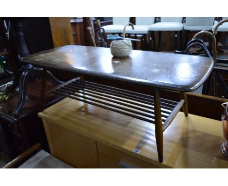 AN ERCOL DARK ELM COFFEE TABLE, with spindled undertier