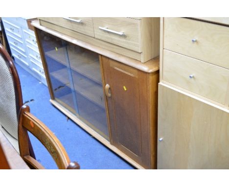 A LIGHT OAK BOOKCASE, with glazed sliding doors and cupboard door