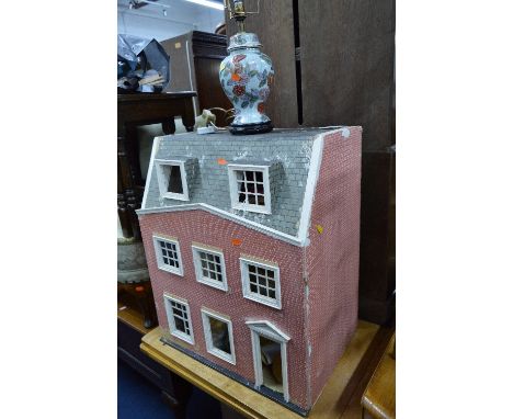A DISTRESSED DOLLS HOUSE, with contents including furniture, etc and an oak nest of three tables, bedroom chair, table lamp a