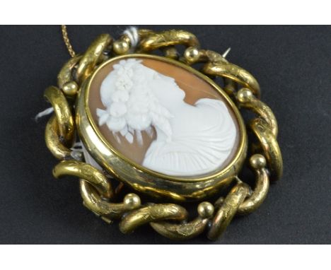 A VICTORIAN CAMEO BROOCH, carved shell cameo with a maiden in profile, with swivel hair locket to reverse, measuring approxim
