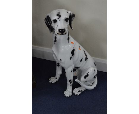 A GLAZED CERAMIC MODEL OF A SEATED DALMATION, approximate height 76cm