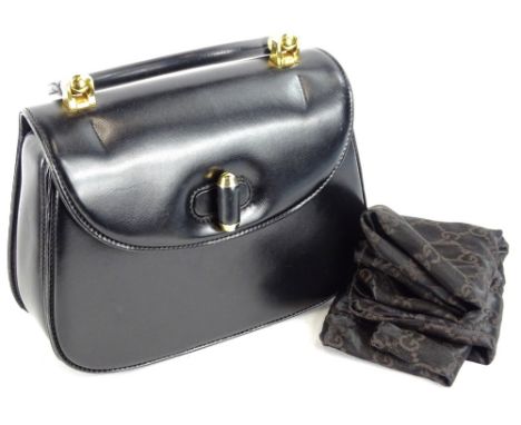 A vintage Gucci black leather top handle bag, with gold hardwear and dustbag.