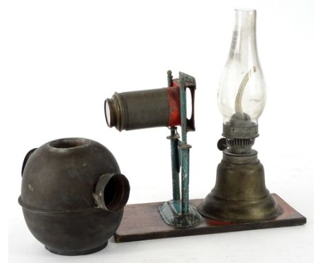An unusual late 19th/early 20thC small magic lantern, with paraffin lamp attachment, lens etc., on a rectangular base, 20cm L