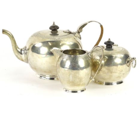 A George V silver three piece tea set, a bullet shaped teapot, with engraved band, ebonised knop and woven handle, a matching