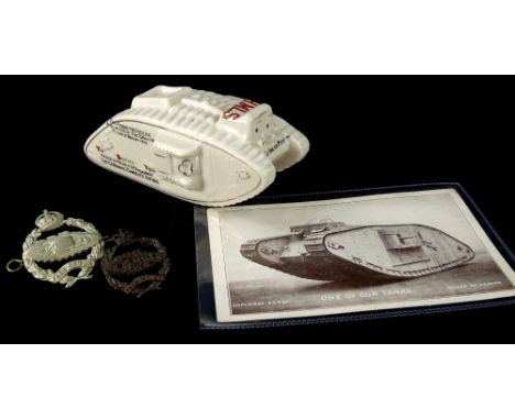 A Carlton crested First World War tank, with crest for Sheffield, a postcard of a tank titled One of Our Tanks, and two tank 