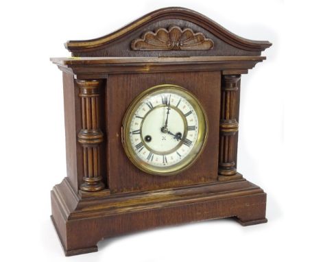 A late 19th/early 20thC Junghans German mantel clock, with an enamel dial, in an oak case, 38cm W.