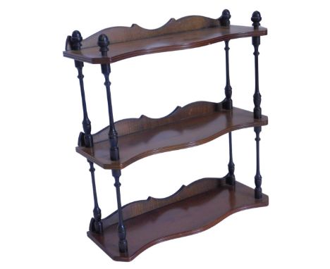 An ebonised and yew three tier wall shelf, with reeded decoration, 49cm W.