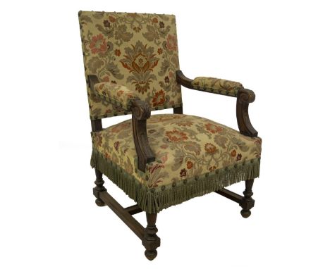 A 19thC French walnut open armchair, with floral tapestry studded upholstery, acanthus carved scroll arms, turned legs with c