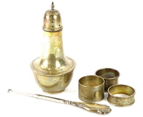 A collection of small silver, to include a sugar castor, button hook and napkin rings, 9oz gross.