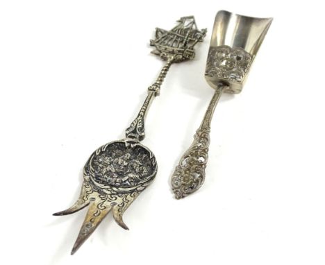 A Continental white metal caddy spoon, modelled in the form of a shovel with pierced decoration and an ornamental white metal