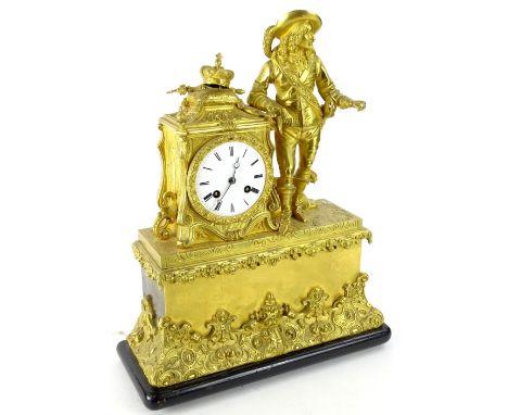 A late 19thC French gilt metal figural mantel clock, the enamel dial decorated with Roman numerals, flanked by a musketeer ty