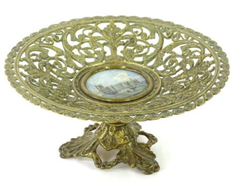 A Victorian gilt metal comport or tazza, with pierced decoration of scrolls, leaves etc., surrounding a central hand coloured