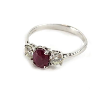 A ruby and diamond three stone ring, with pigeon cut ruby approx 1.78cts, flanked by two round brilliant cut diamonds, each a