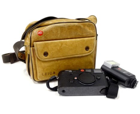 A Leica M6 camera body, lens covers, a SF20 Leica flash and a bag.