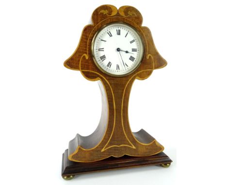 An Edwardian mahogany and marquetry mantel timepiece, modelled in the form of a stylised tree, the white enamel dial with Rom