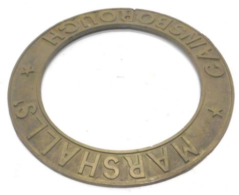 A cast brass steam or traction engine roundel, stamped Marshalls Gainsborough, 55cm dia.