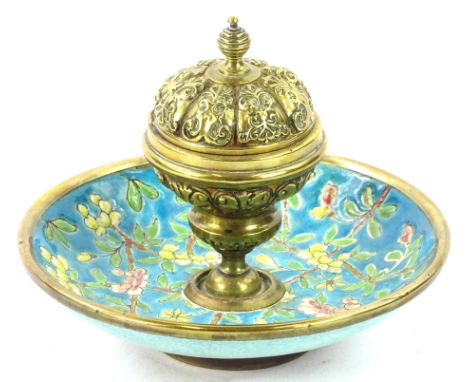 A late 19thC French brass and enamel inkwell, the hinged lid cast with scrolls etc., enclosing a vacant interior, the dished 