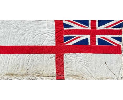 A large Royal Navy white ensign. Of multi-sectional construction, printed broad arrow mark and numbered 571 3293, approximate