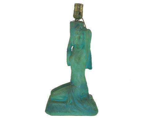 A Continental pottery table lamp. 1930s, modelled as a seated female with an Egyptianesque headdress, kneeling on a tapered r