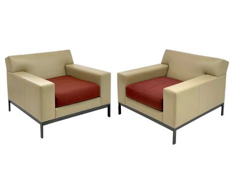 A pair of Christian Liaigre cream leather armchairs. With woven silk cushions, on metal frames, height 71cm, width 89cm, dept