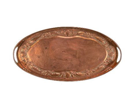 A Newlyn copper oval twin handled gallery tray. Early 20th century, the border repousse decorated with fish, shells, and seaw