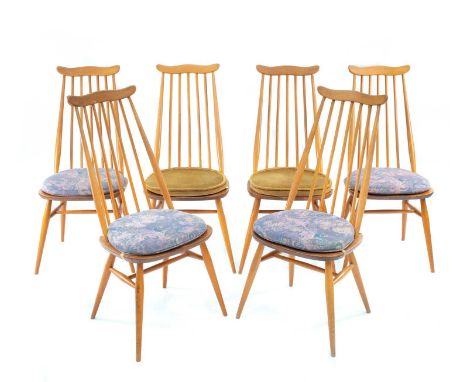 A set of six Ercol Blonde dining chairs. With stick backs and turned tapering supports.