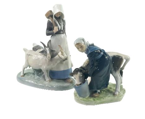 A Royal Copenhagen figure of a cow and milkmaid.  Model number 779, Length 16cm, Height 16cm; Together with another Royal Cop