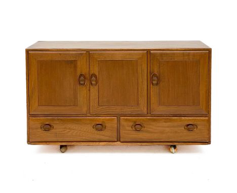 An Ercol Windsor light elm sideboard. With a double cupboard and single cupboard revealing a single shelf and cutlery drawer 