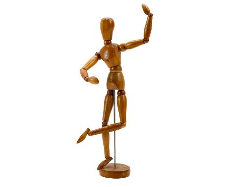 A wooded articulated artists mannequin. Height 34cm.