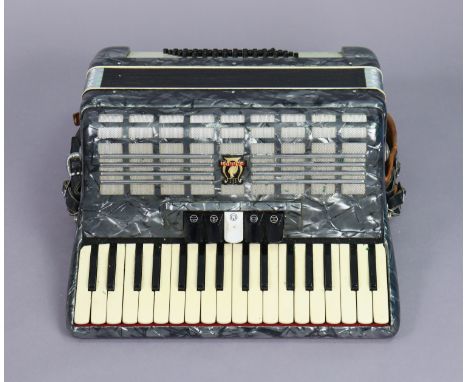 A Parrot piano accordion with a fibre-covered travelling case. 