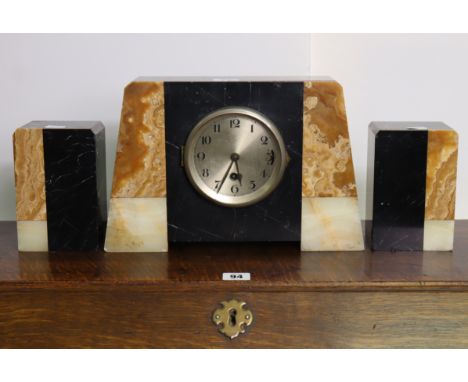 An Art Deco black slate &amp; marble clock garniture comprising of mantle clock, 8¼” high; &amp; a pair of side vases, 6” hig