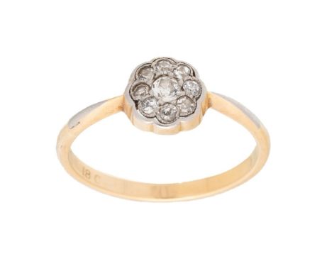 An 18ct gold and diamond vintage flowerhead ring, the central diamond of approximately 3.3mm diameter, surrounded by eight sm