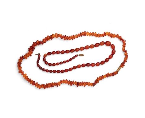 Two strings of clear cognac amber, comprising a string of oval beads, 8.7g, and another of naturalistic shaped beads 16.6g.