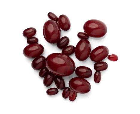 A group of bakelite cherry amber beads, of oval form, the largest with significant marbling and  measuring 32.7 by 23.9, smal