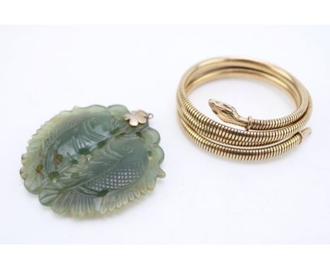 A rolled gold serpent arm bangle and a spinach nephrite pendant carved as two fish, with silver flower hanger.
