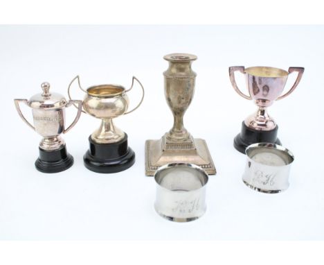 Hallmarked silver candlestick, together with some small silver coloured trophies &amp; napkin rings with indistinct marks, to