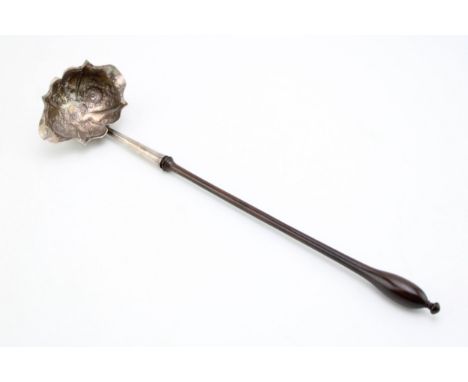 A George III silver toddy ladle, the chased and repousse bowl with double pourer, with turned handle, total length 36cm.