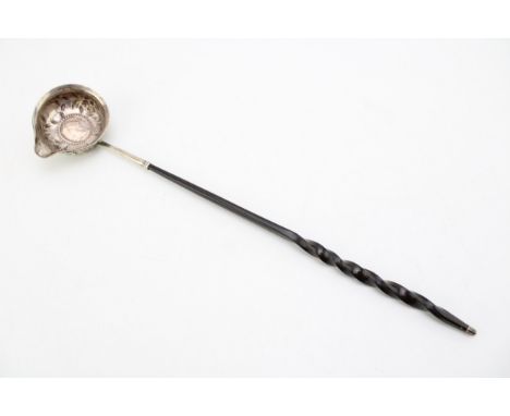 A silver toddy ladle, likely 18th century with Queen Anne half crown inset, the bowl with rococo chased and repousse floral d